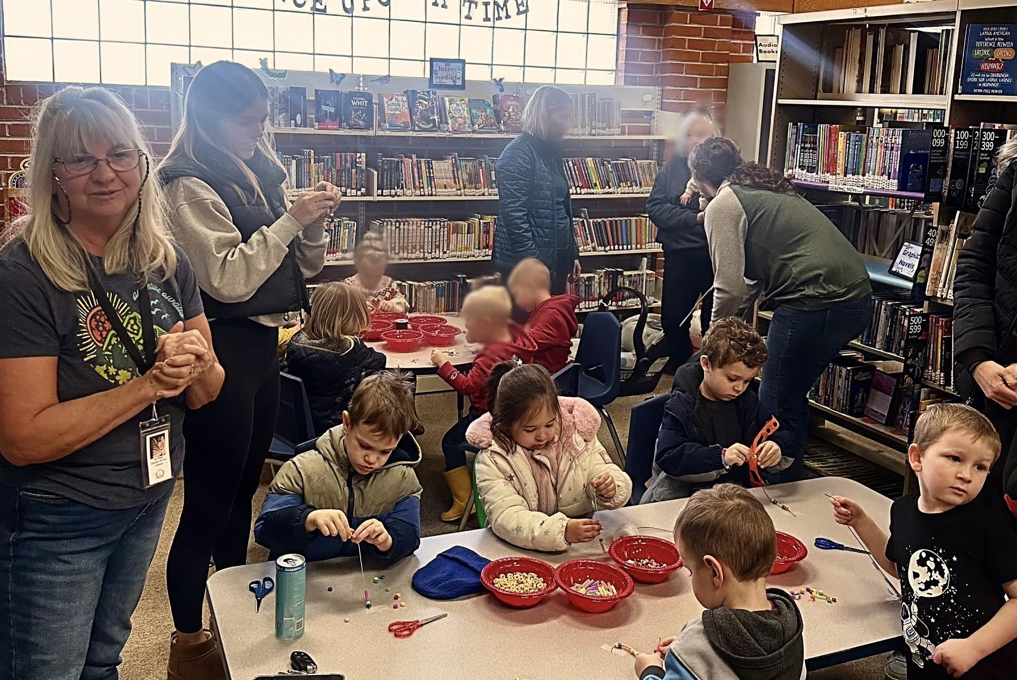 Kids gathered around a table doing crafts