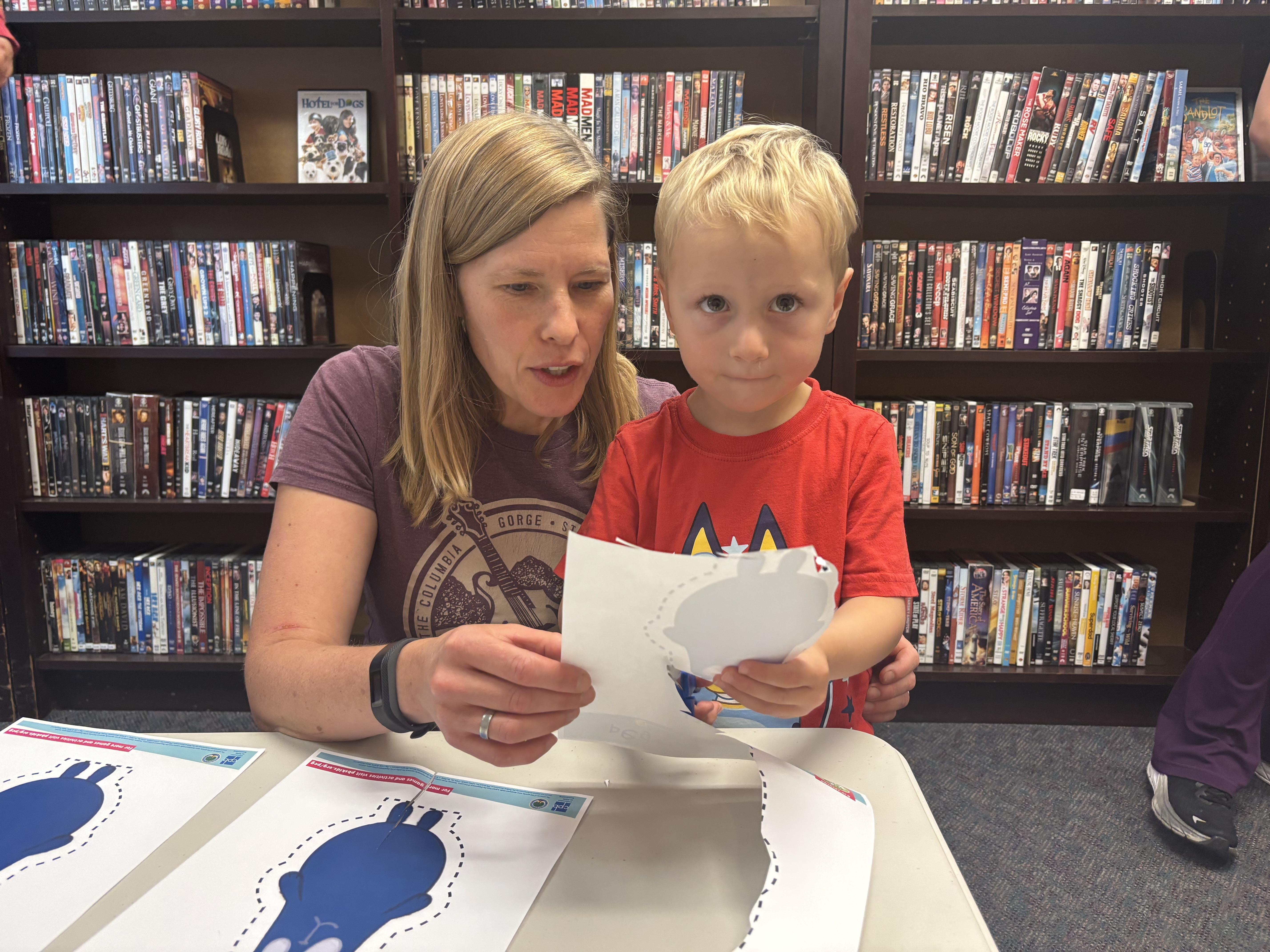 A mom and her kid do Peg + Cat math activities