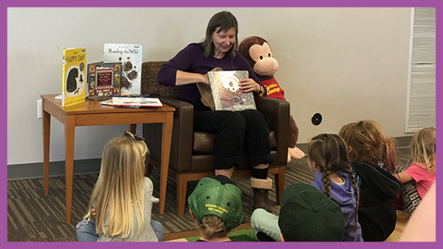 Woman reading to a group of children