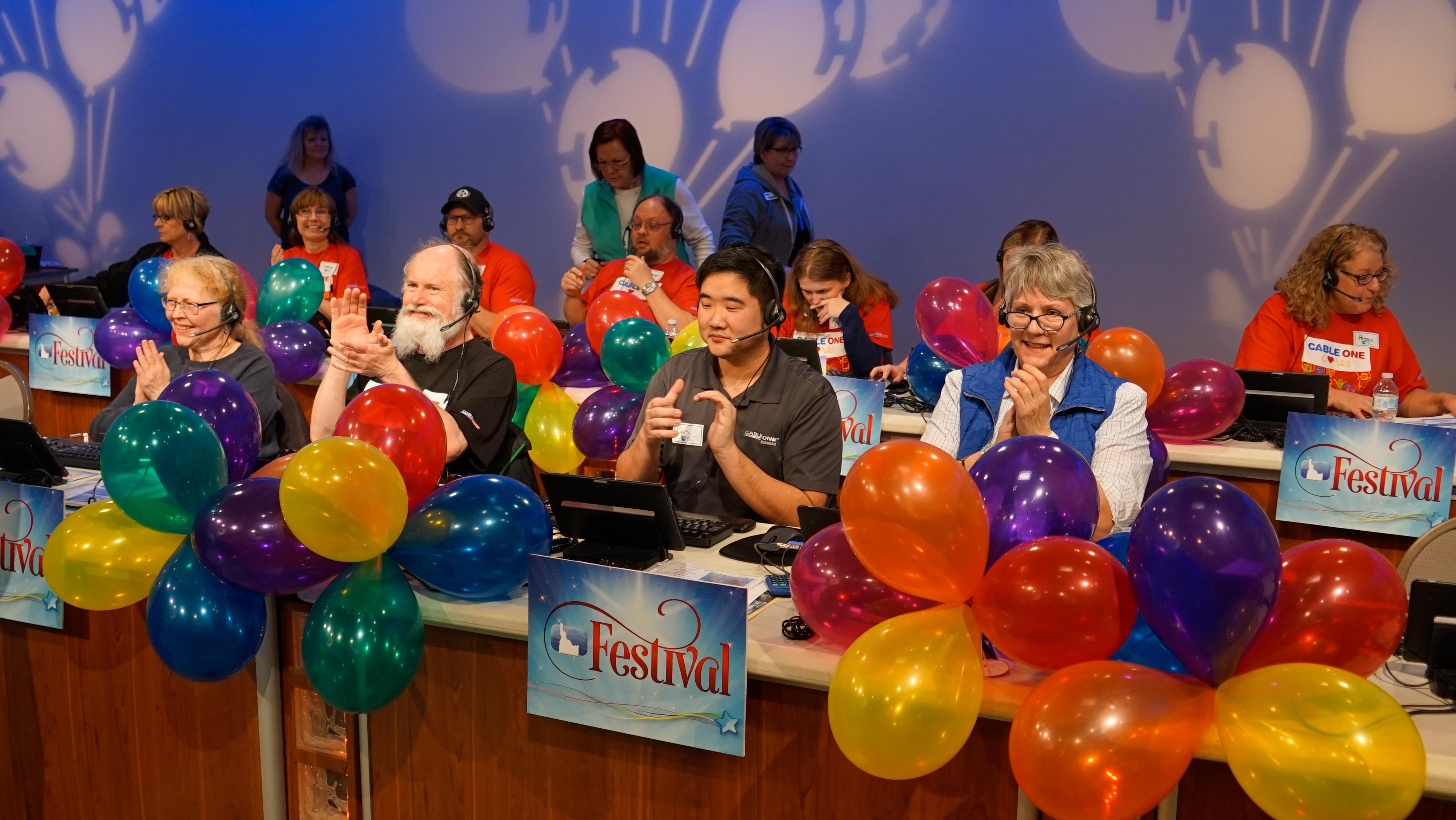 Volunteer group answering phone pledges during fundraising event