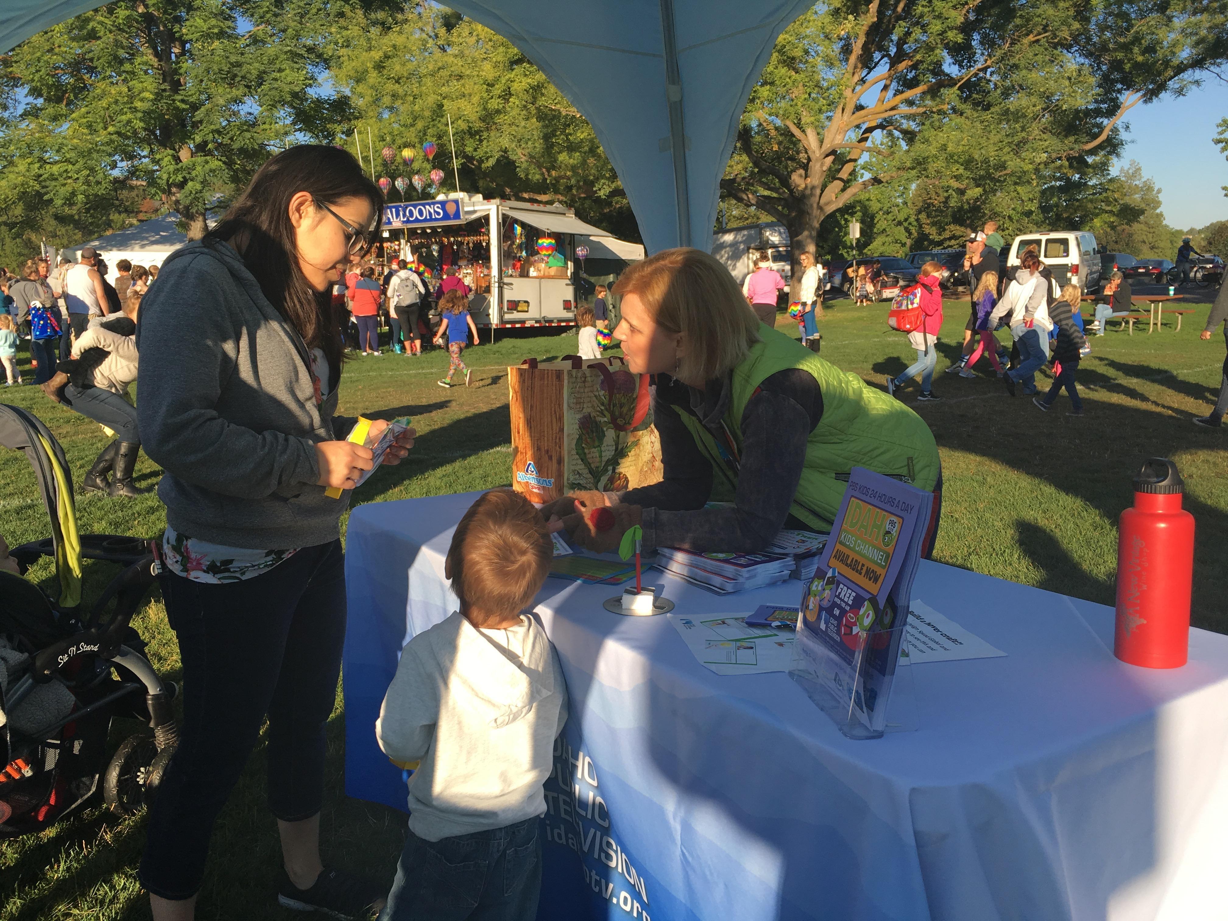 Woman volunteering at a booth