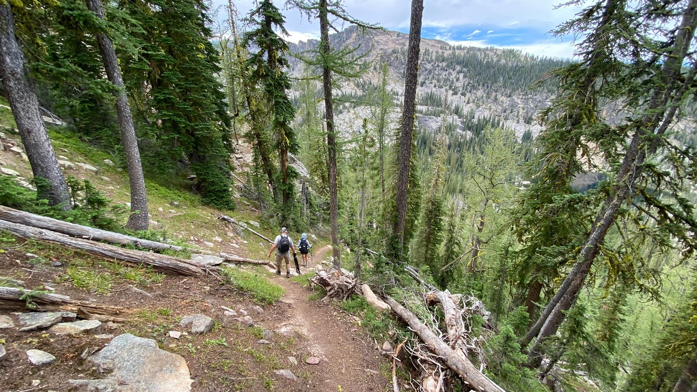Two hikers descending the mountain trail