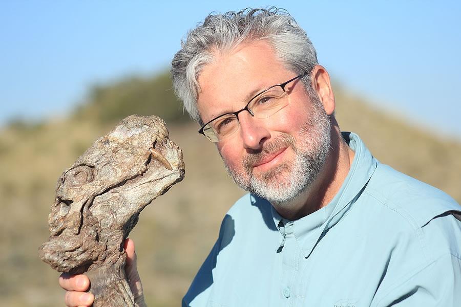 Neil Shubin holds a fossil of gorgonopsid