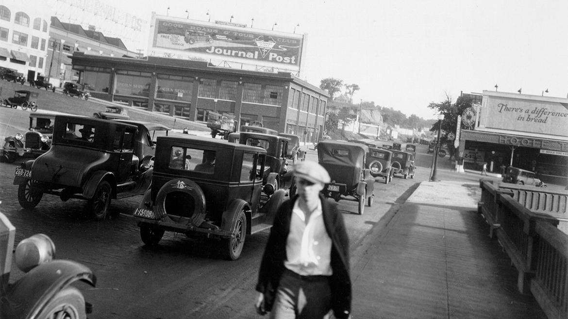 Black and white photo of McGee street f rom 1925 with old cars on it