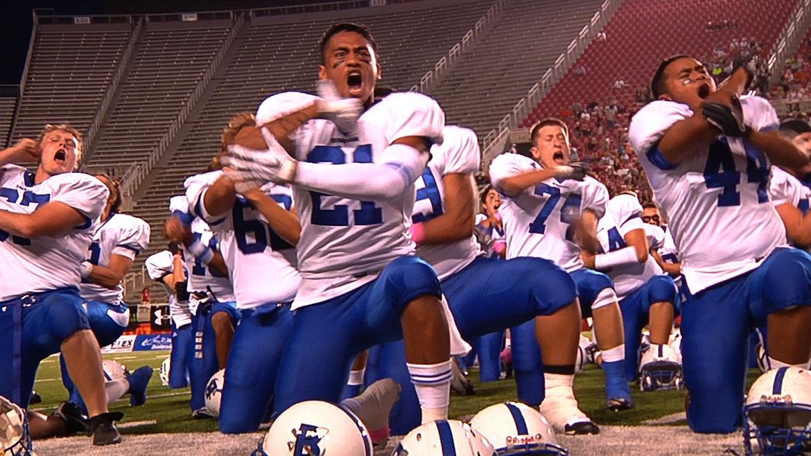 Members of a football team on the field stretch before their game