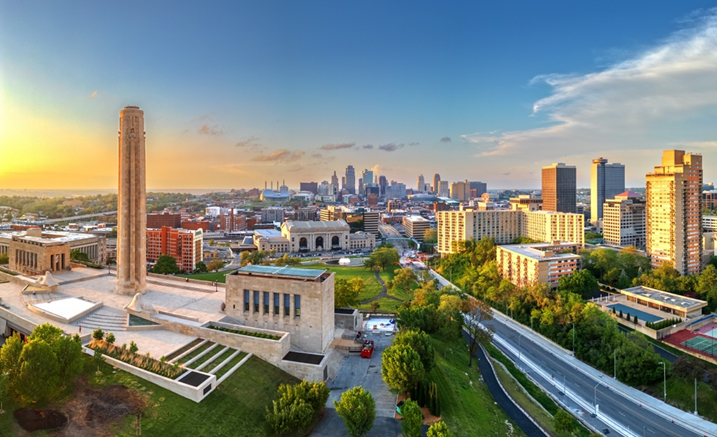 An aerial photo of Kansas City, with Liberty Memorial on the left side of the image and skyscrapers on the right, stretching into the center distance