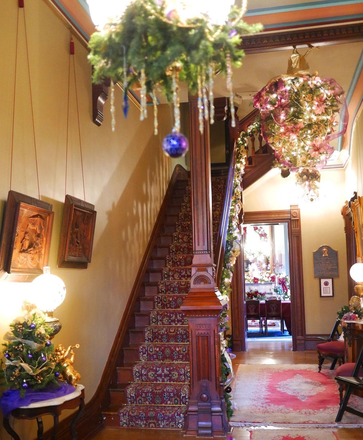 The front entrance in the Vaile Mansion. Notice the Christmas tree hung upside down from the chandelier, just as Queen Victoria used to do. 