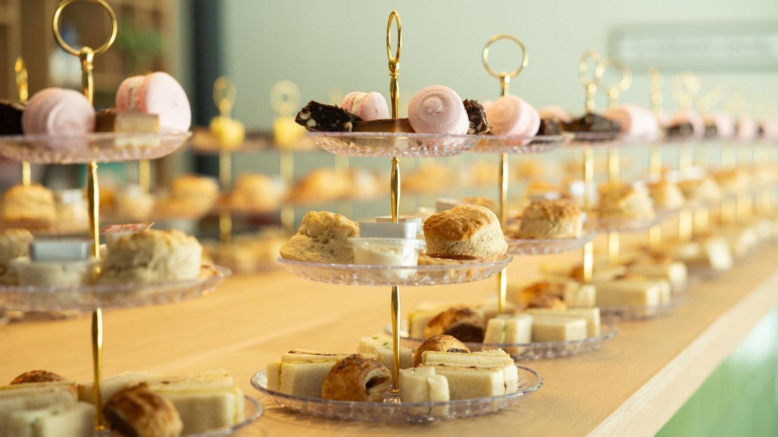 Three tiered pastry stands filled with a variety of treats.