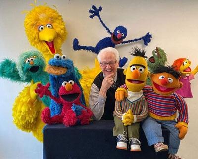 Gary Brock, surrounded by the Sesame Street characters