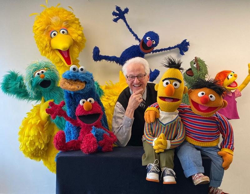 Big Bird, Grover, Cookie Monster, Elmo, Bert, Ernie and other characters with Gary Brock in center