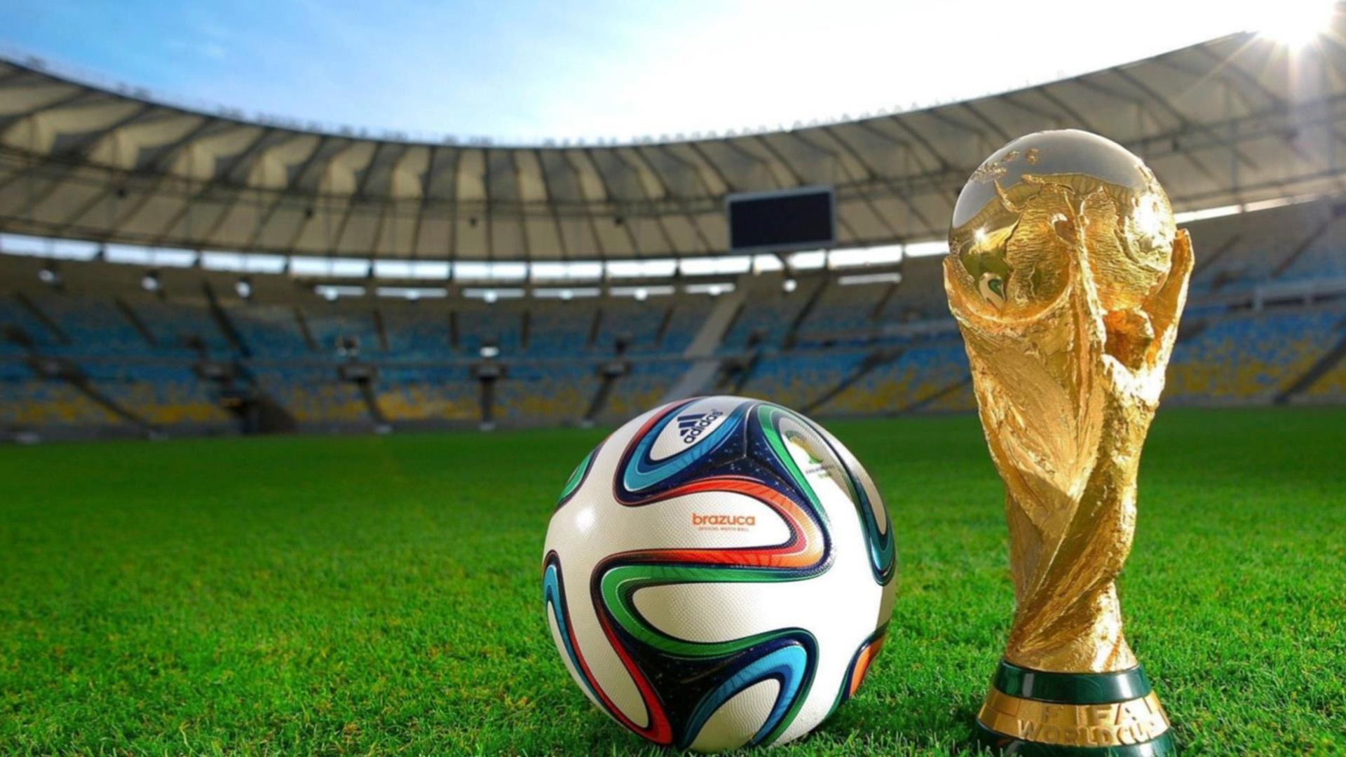 Soccer ball and World Cup trophy in soccer stadium