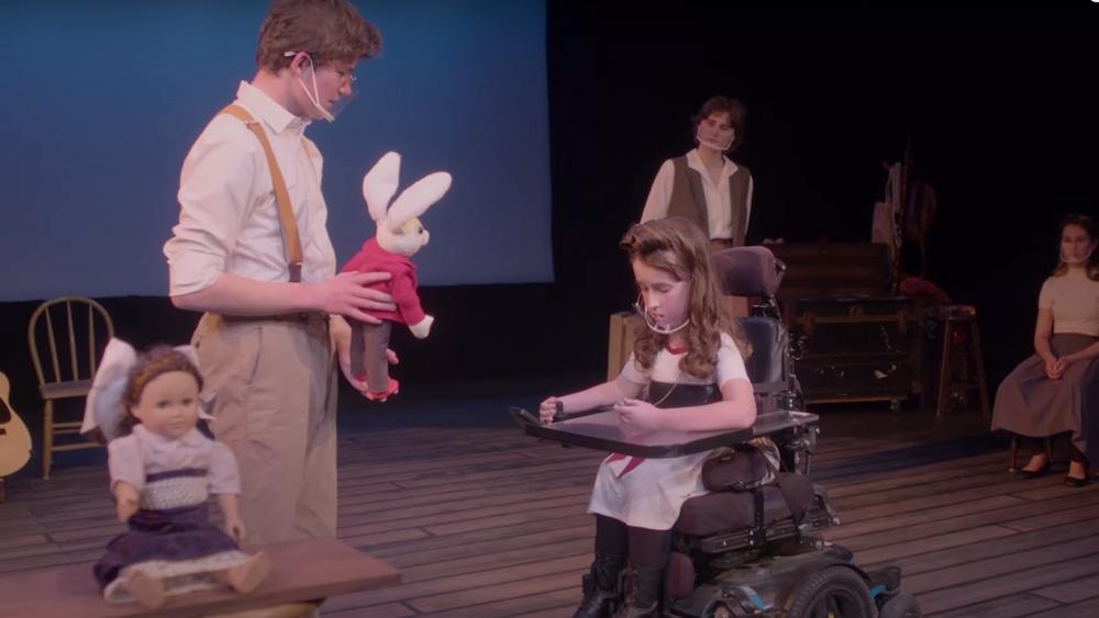 Players on stage: young man with stuffed rabbit, girl in motorized chair