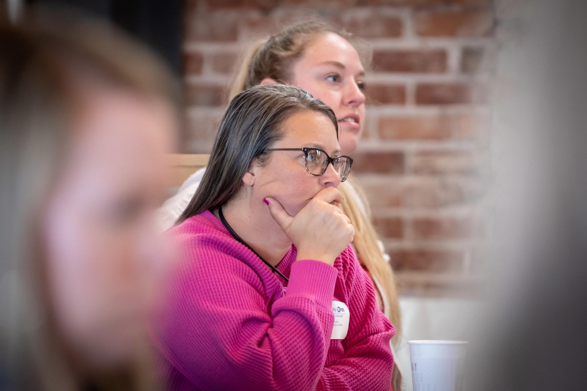 A teacher listening intently to a workshop at Kansas City PBS