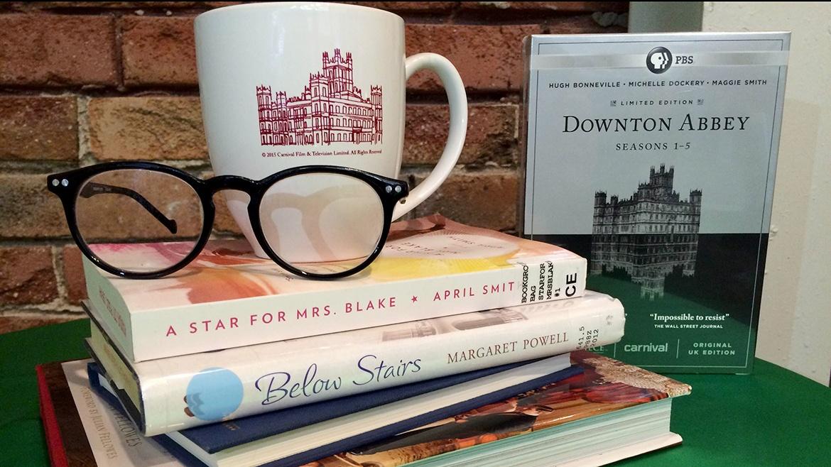 stack of books with glasses and coffee mug on top