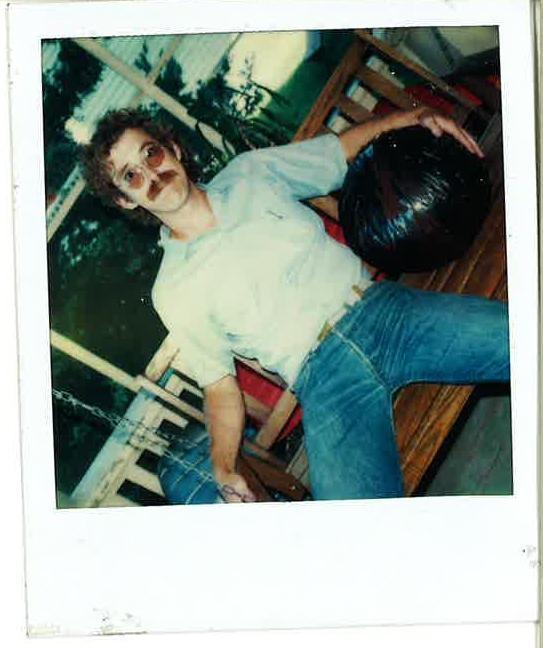 old picture of a young man on a bench with a big ball of tape