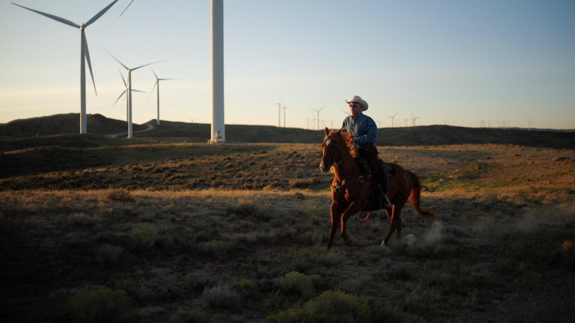 Chris Navarro rides through wind farm