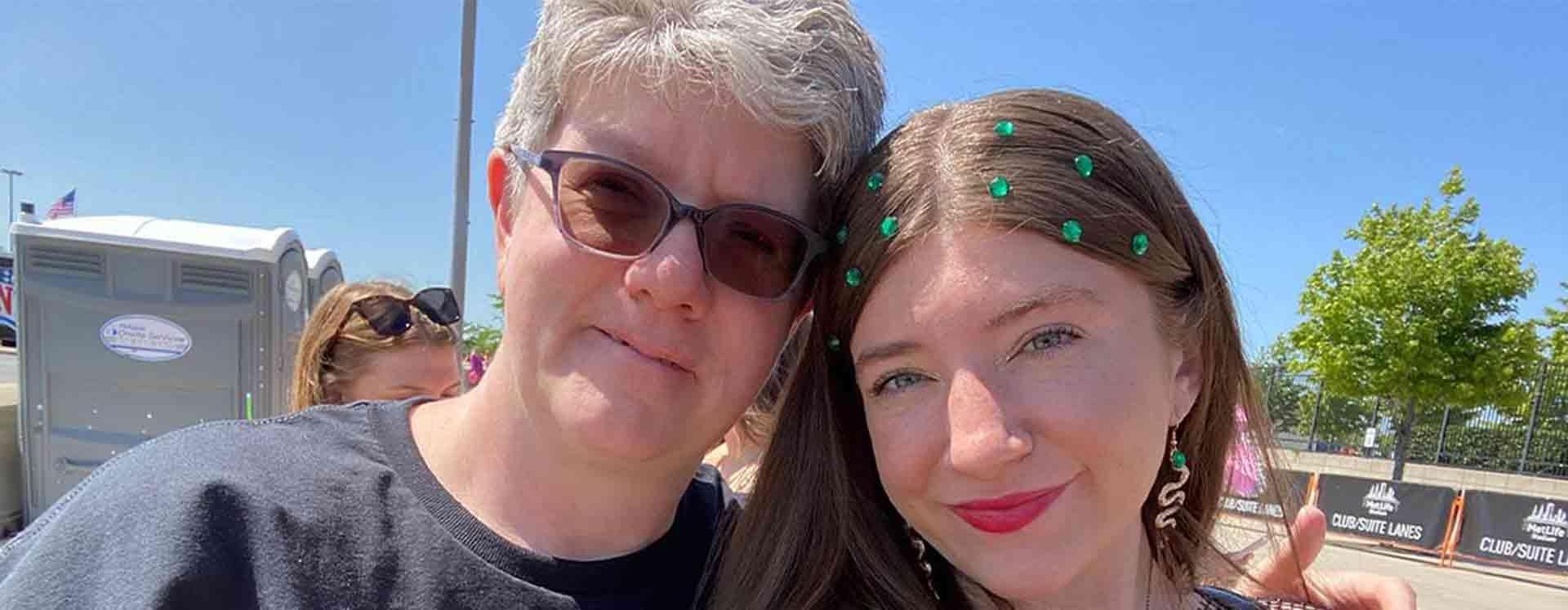 Reese McQueen and her mom Janine dressed in honor of Taylor Swift's 'Reputation' era, both are dressed in all black and Reese has green jewels in her brown hair. 