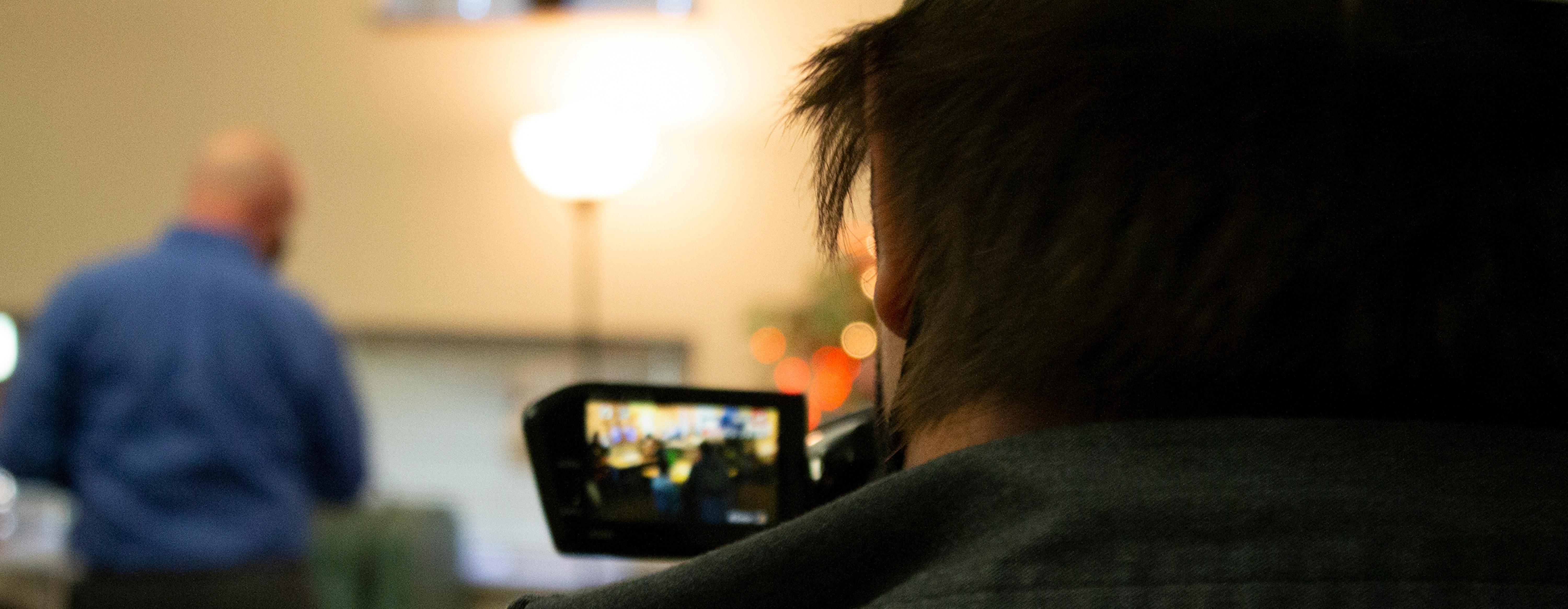 Image: photograph of a Standing Rock High School student documenting Literacy Day on a Prairie Public camcorder.