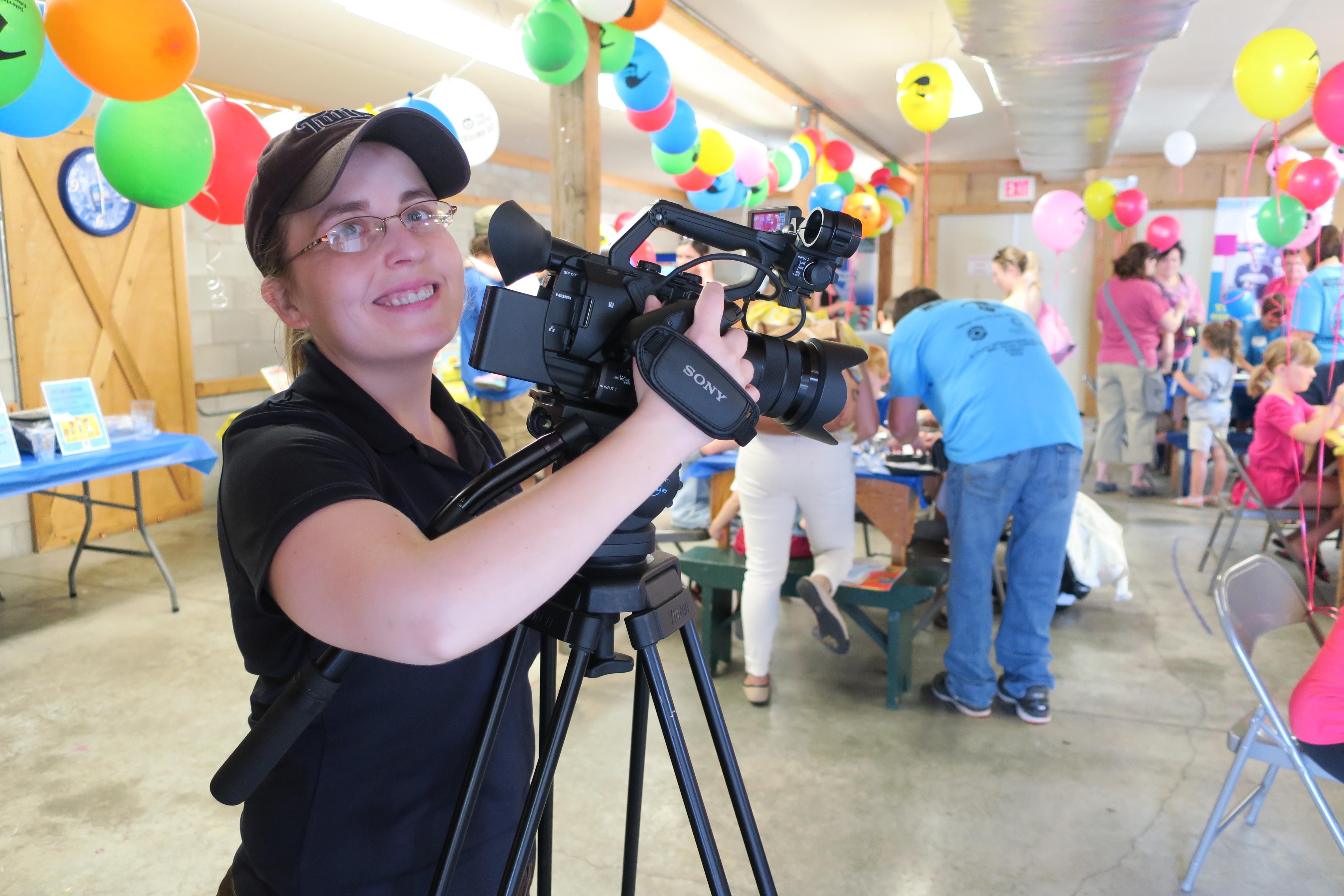 Videographer with camera at childrens' event