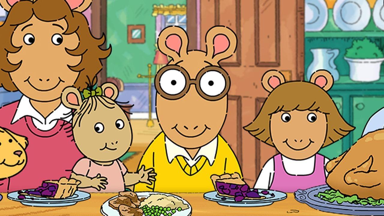 Arthur, the PBS KIDS character, sits at a Thanksgiving table with his family.