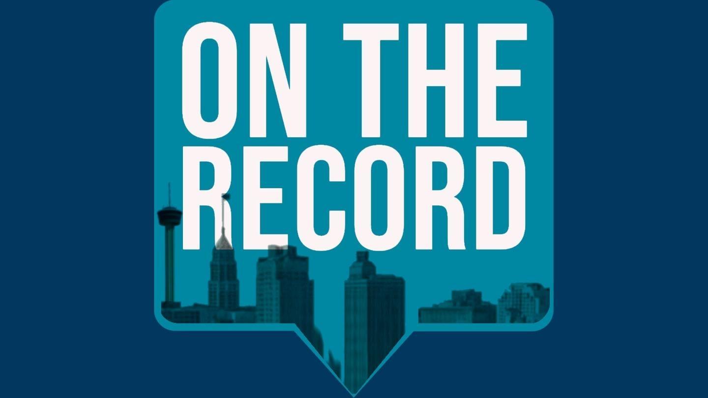 on the record logo - blue speech bubble with the words "On The Record" behind the San Antonio skyline