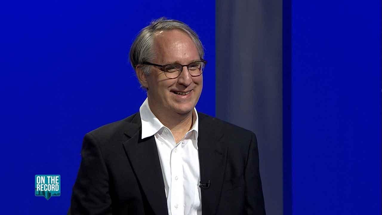 Brian Petkovich, President of the San Antonio Philharmonic smiles during On The Record interview