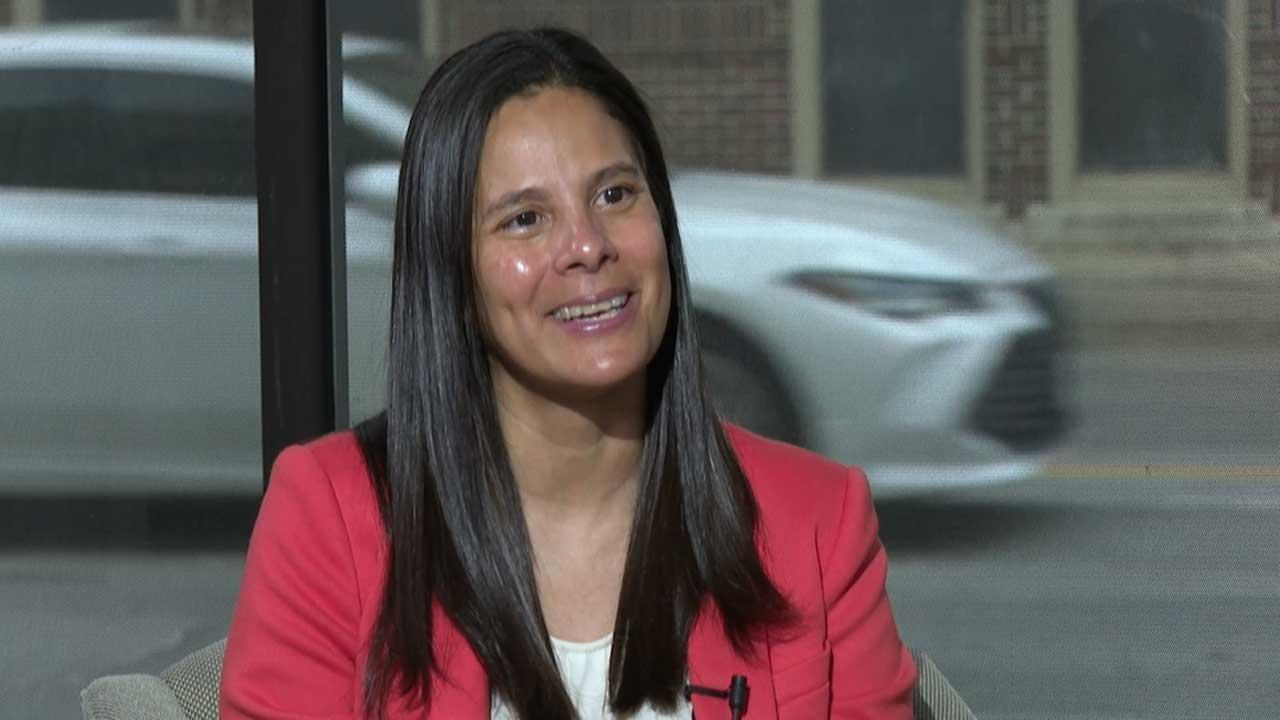 A smiling woman in a red jacket