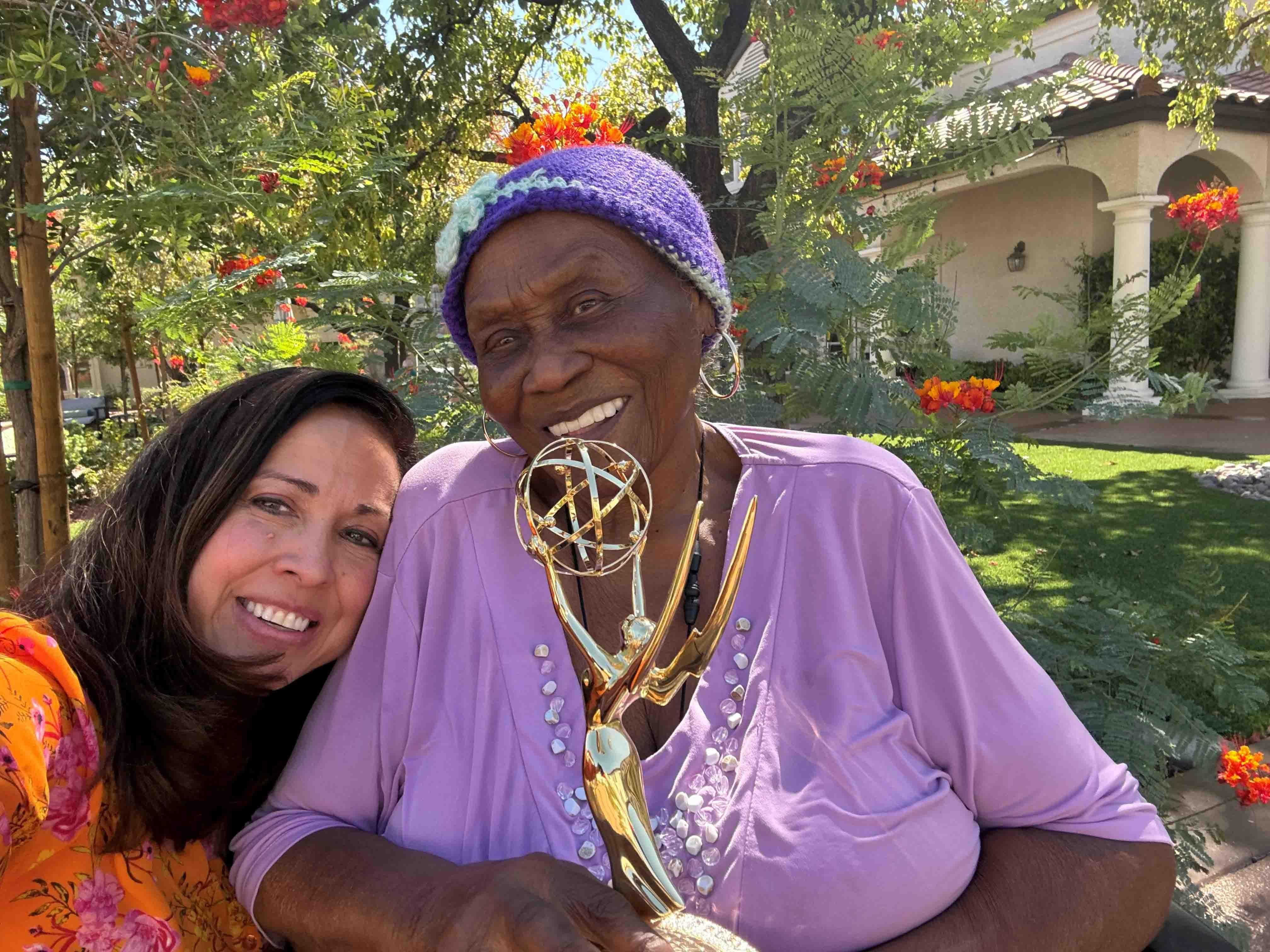 Maria Silva with Ruby Duncan, holding an Emmy award statuette