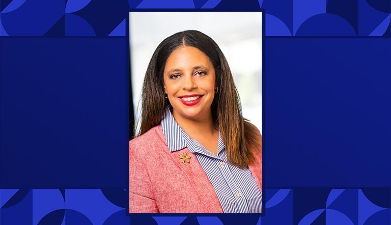 Angie Carr headshot against a blue patterned background