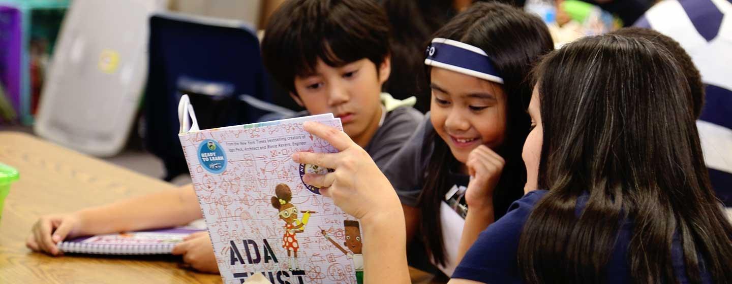 Children read from the book "Ada Twist, Scientist," provided by Ready To Learn