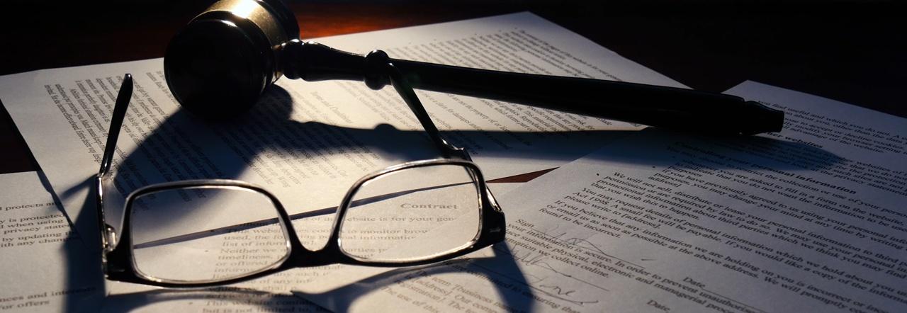 eyeglasses legal documents gavel on a desk