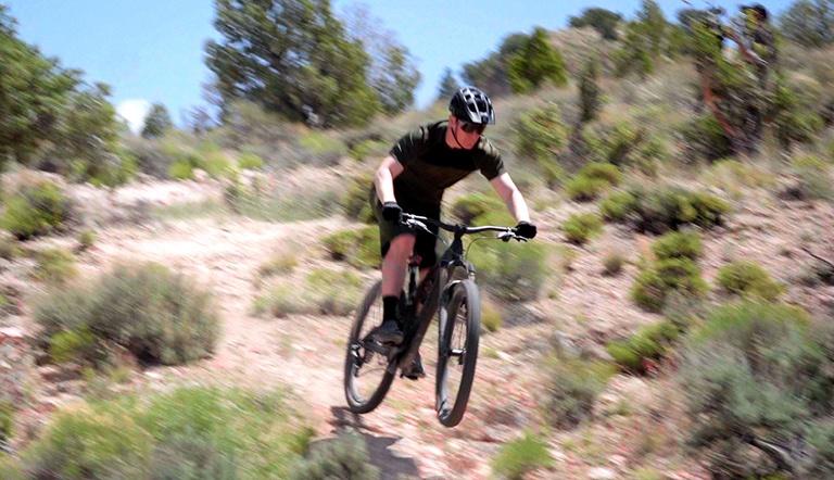 Connor Fields riding a mountain bike on a desert trail