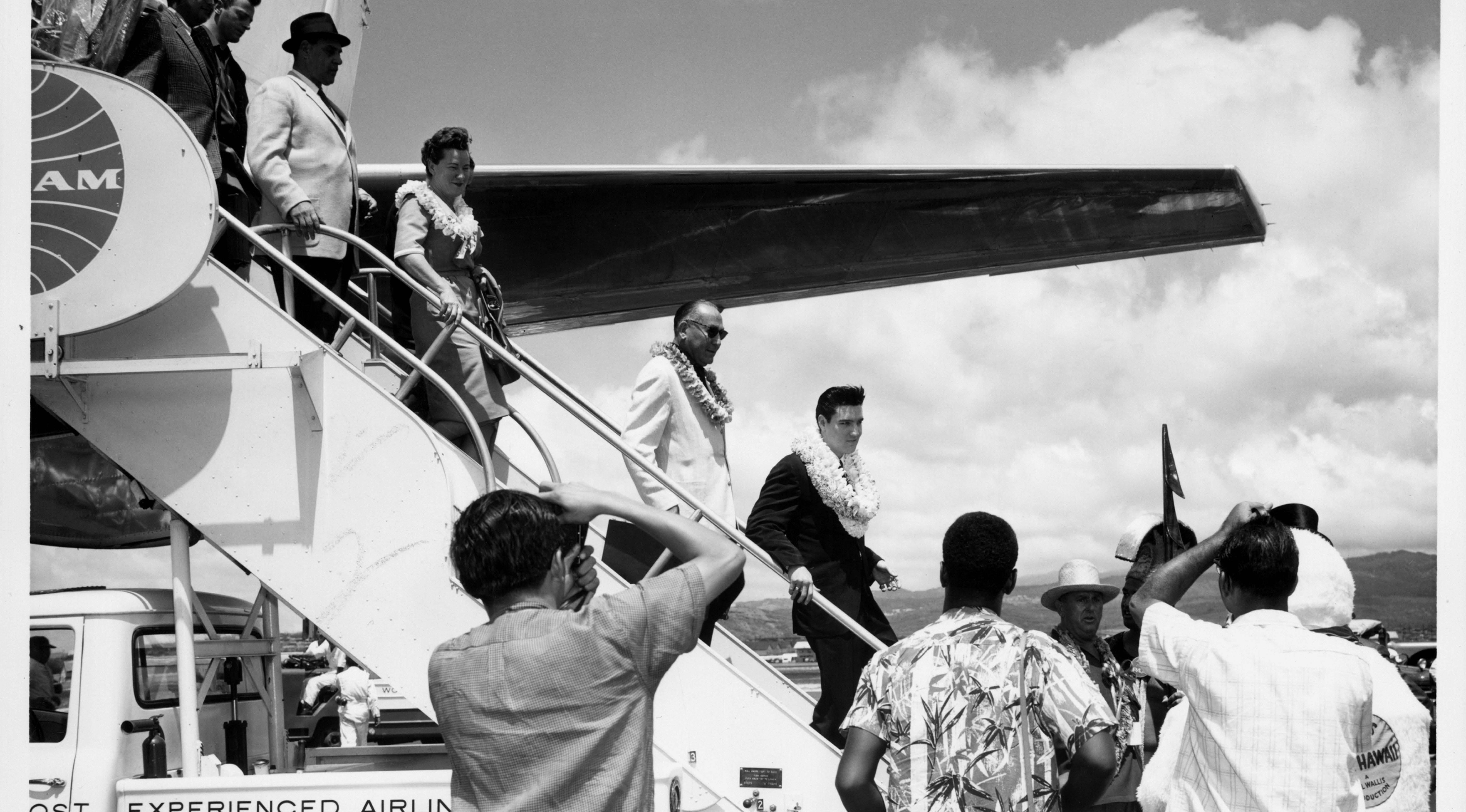 Elvis Presley and others descend from airplane in Hawaii