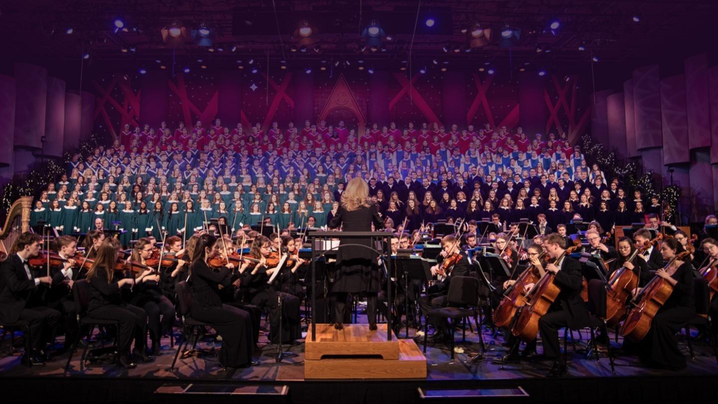 the orchestra and choir on stage with conductor