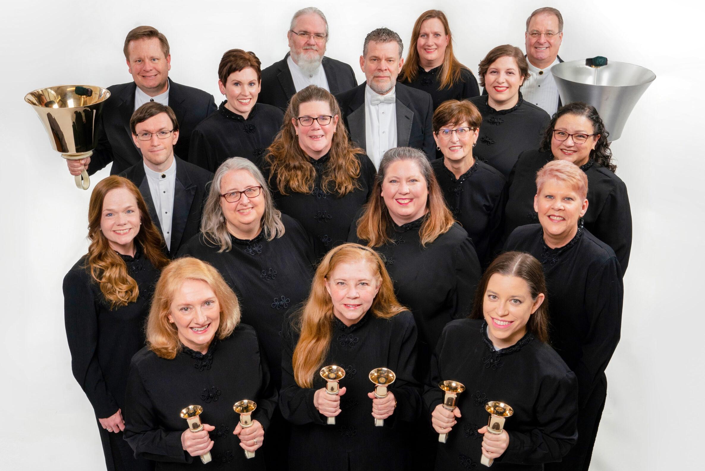 the choir in black dress attire holds up bells