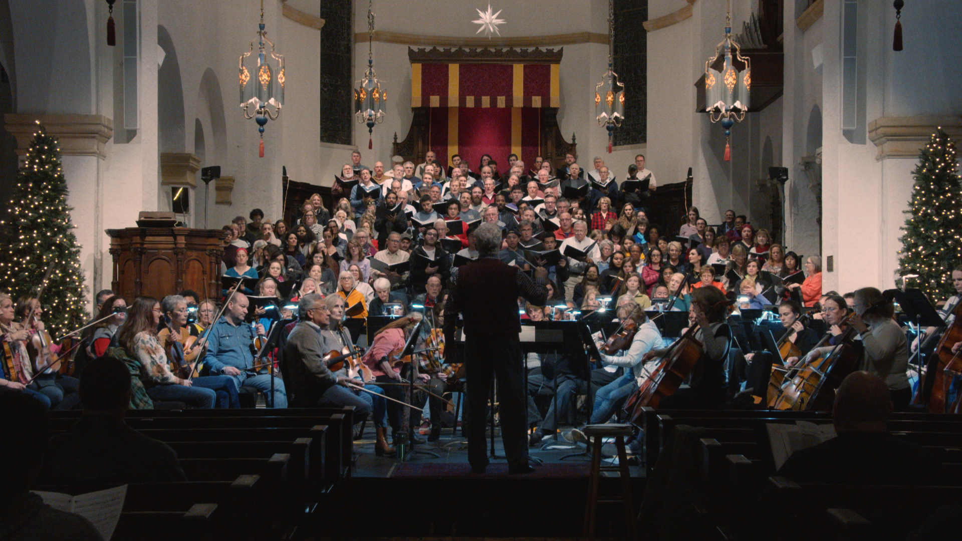 the choir and orchestra in the chapel with a conductor