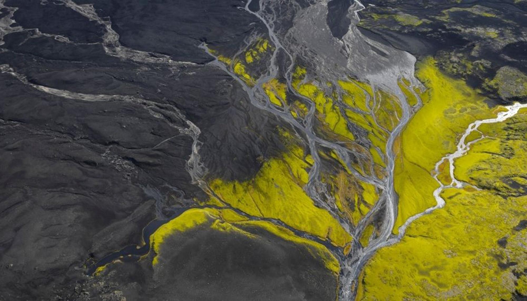 An ariel photo of a landscape with rivers and hills.