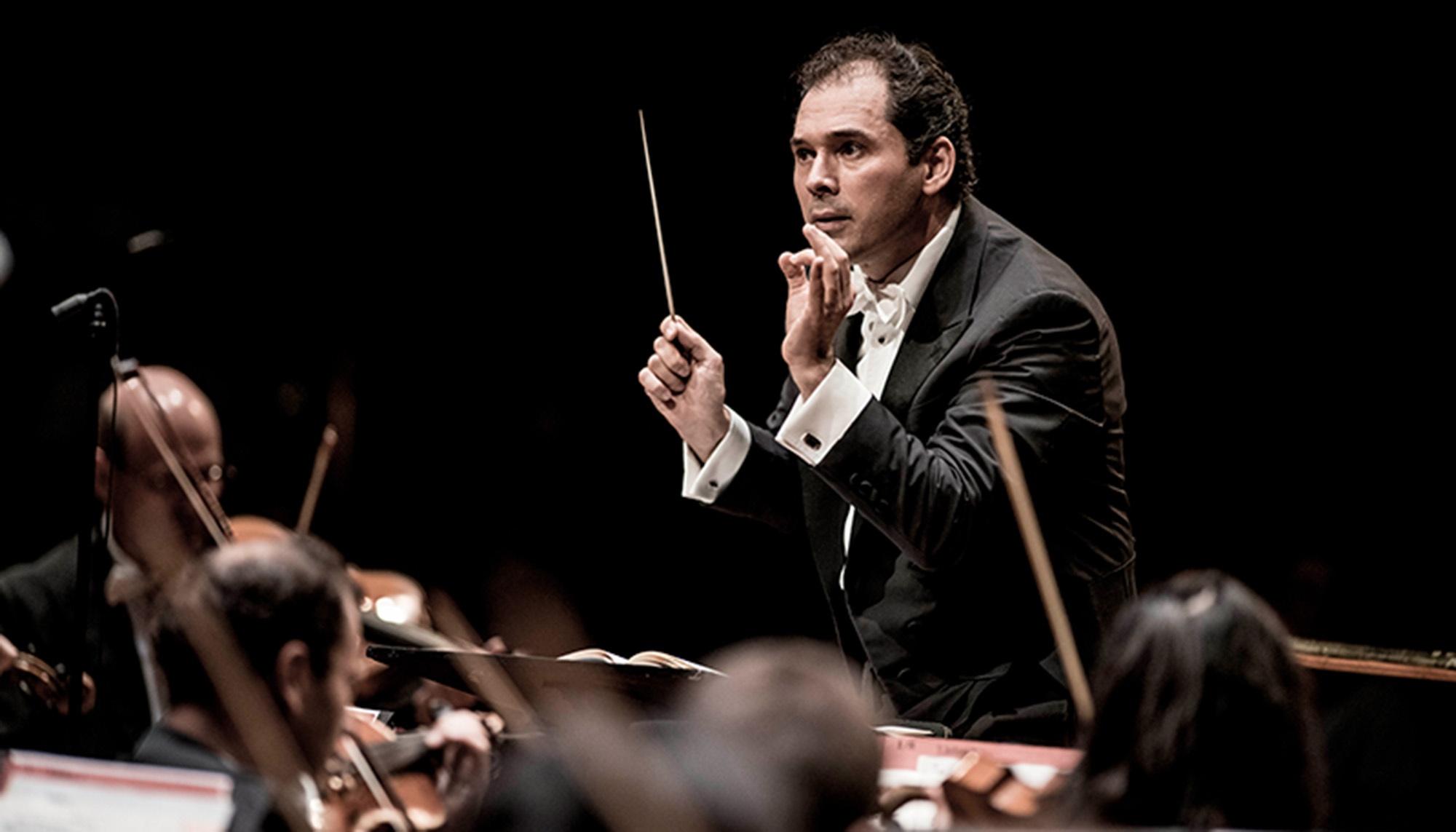 The Vienna Summer Night Philharmonic orchestra playing with a conductor.