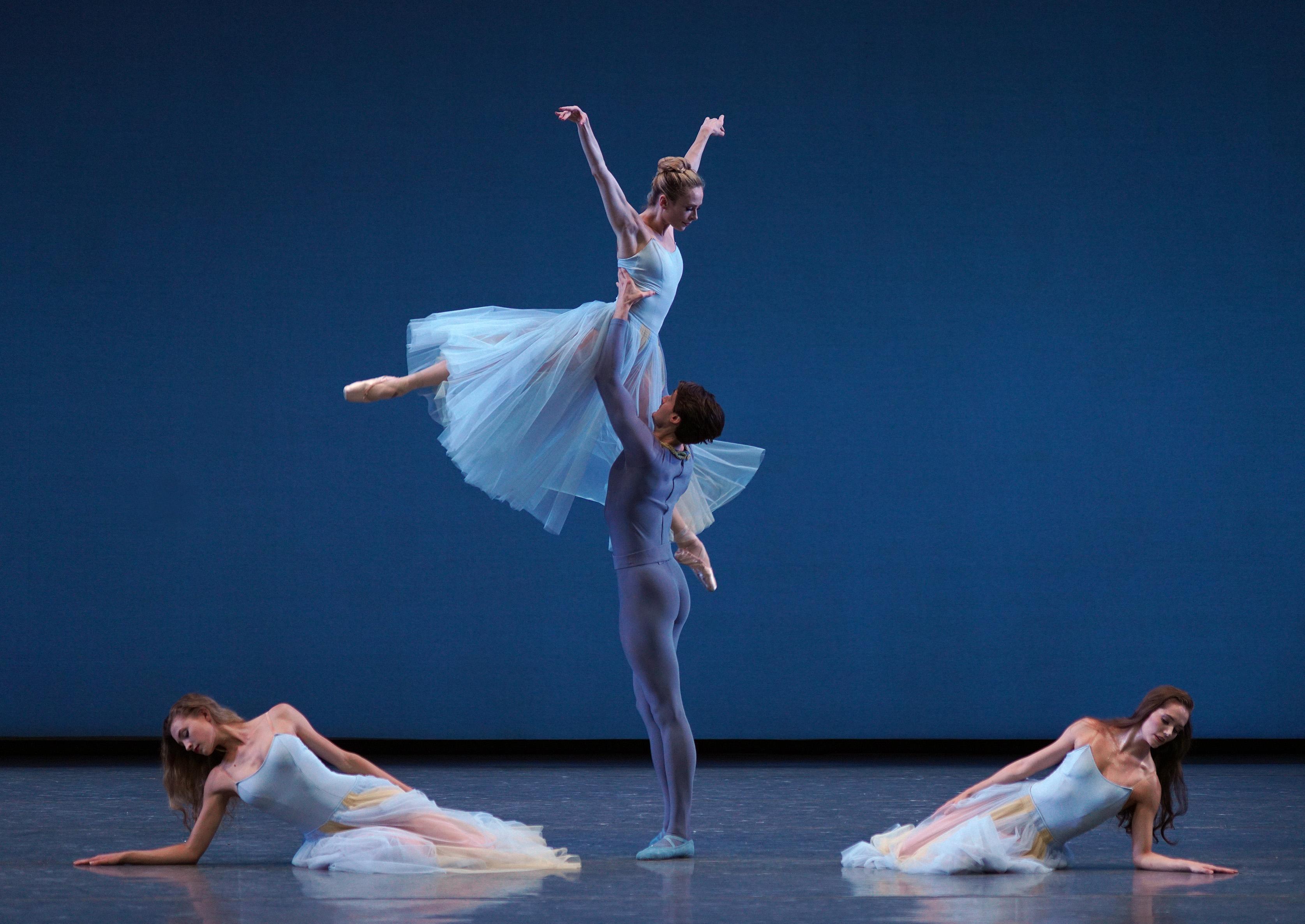 Three ladies and a man dancing in a ballet performance