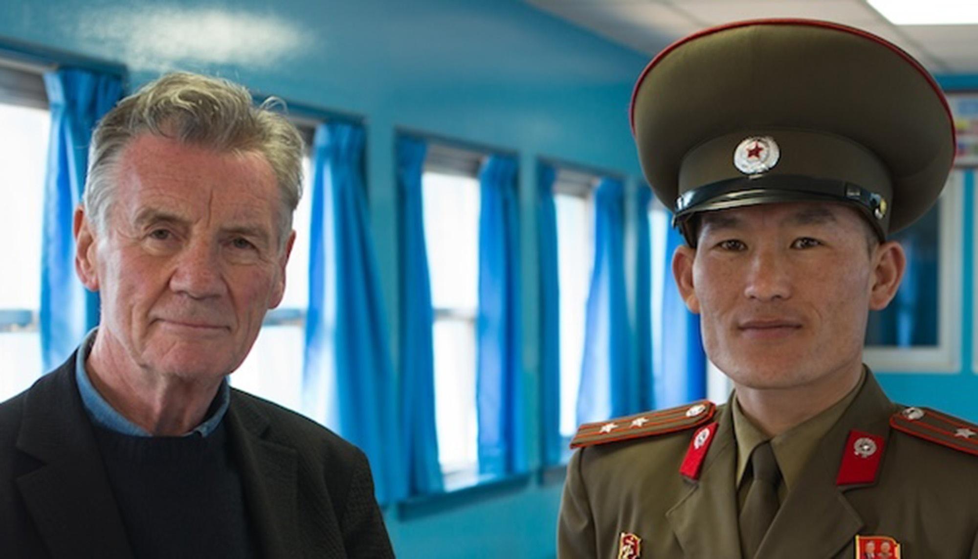 Michael Palin standing with a Korean soldier in the Korean Demilitarized Zone.