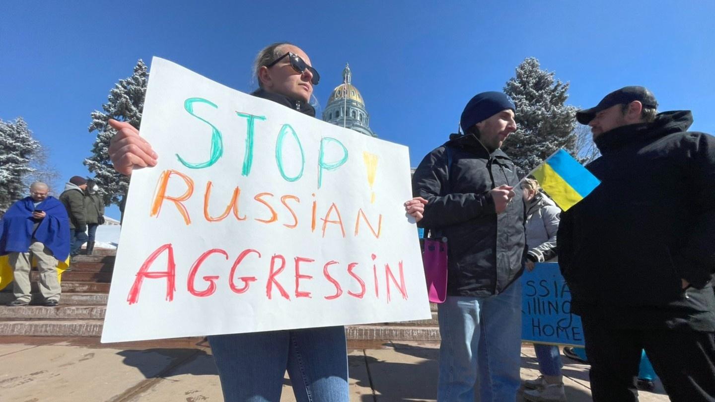 A woman holds a sign outside the Colorado State Capitol Thursday, Feb. 24, opposing the Russian invasion of Ukraine.
