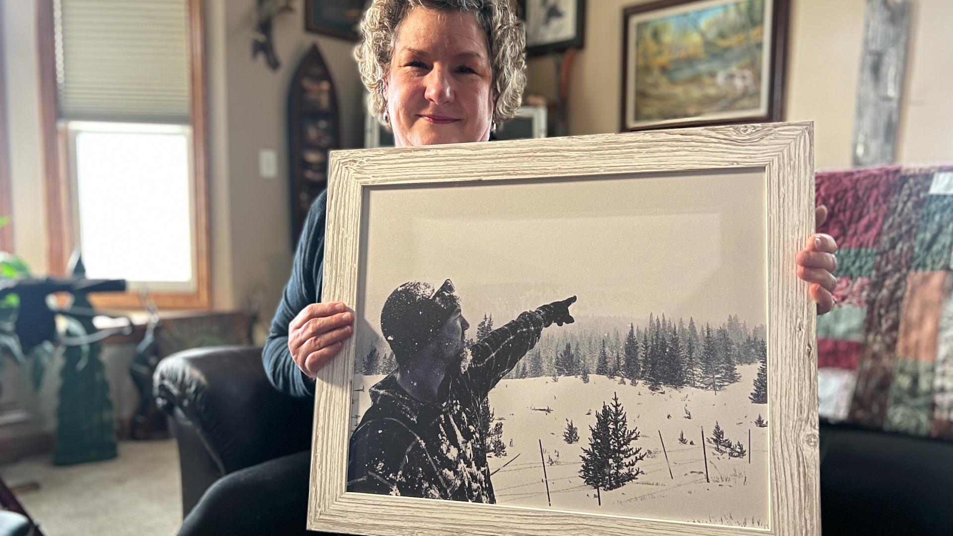 Sheila English-Ogden holds a framed portrait of her son Zach during a trip to the Front Range Foothills to find a Christmas tree.