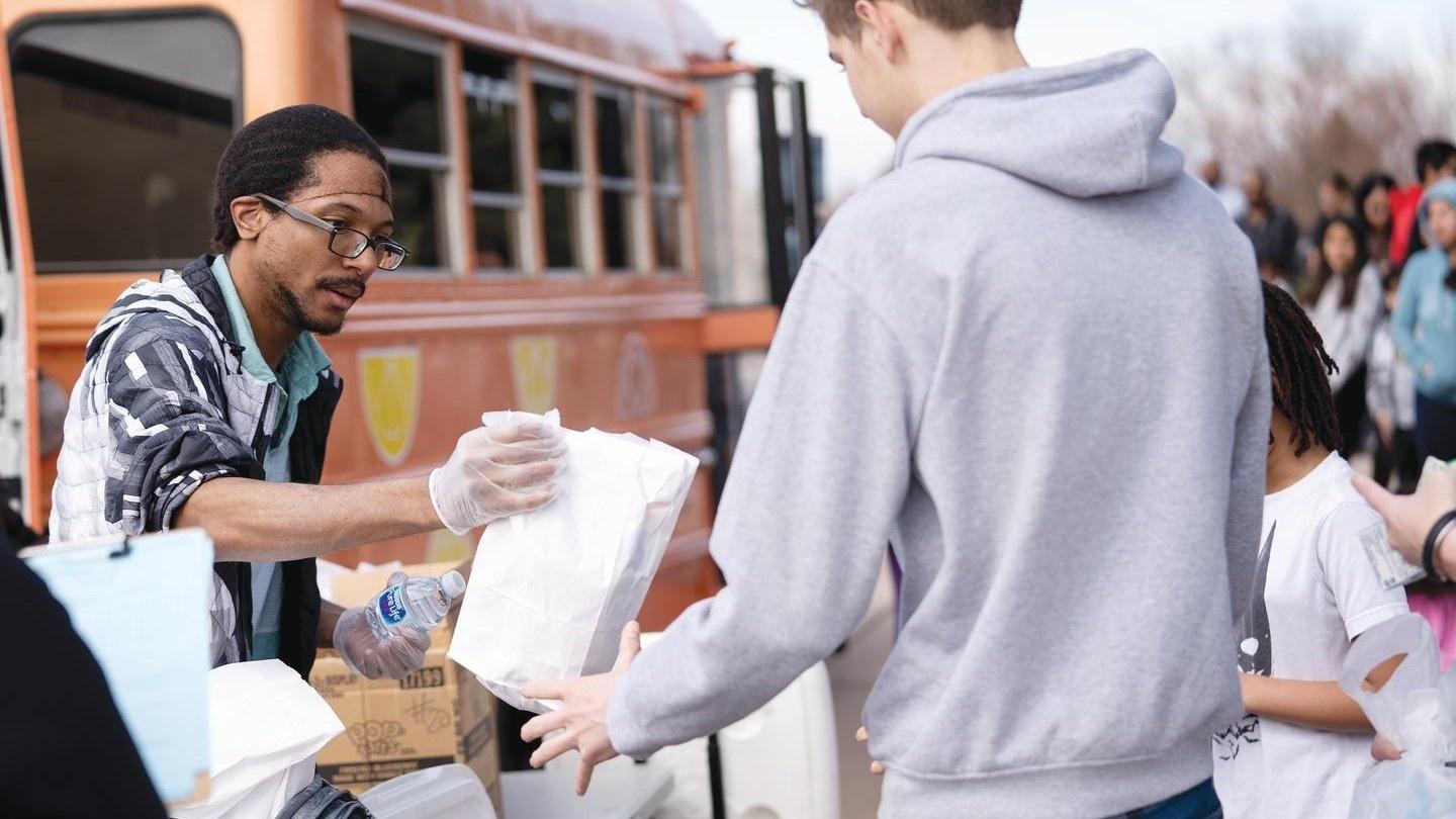 Berkley Jenkins hands out free breakfasts and lunches to families of Aurora Public School Students, March 17, 2020 at Dalton Elementary.