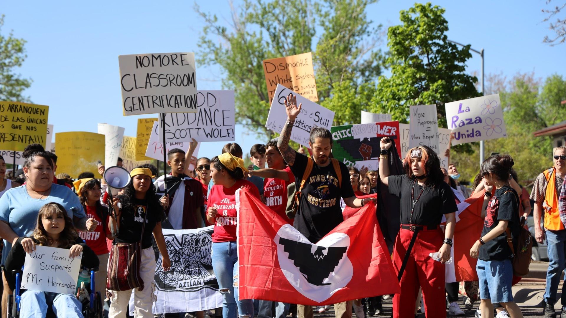 Tim Hernández, center, marches down W 38th Ave with a group of students, teachers and community members Friday, May 13 2022.