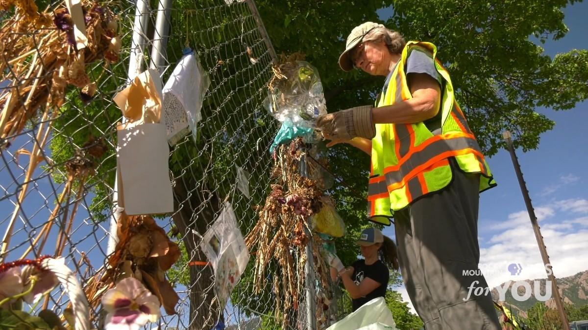 Volunteers, museum staff, and city workers remove items from the King Soopers shooting memorial in Boulder.