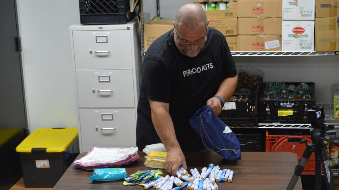 Founder of Period Kits, Geoff Davis, packs a three-month kit full of supplies