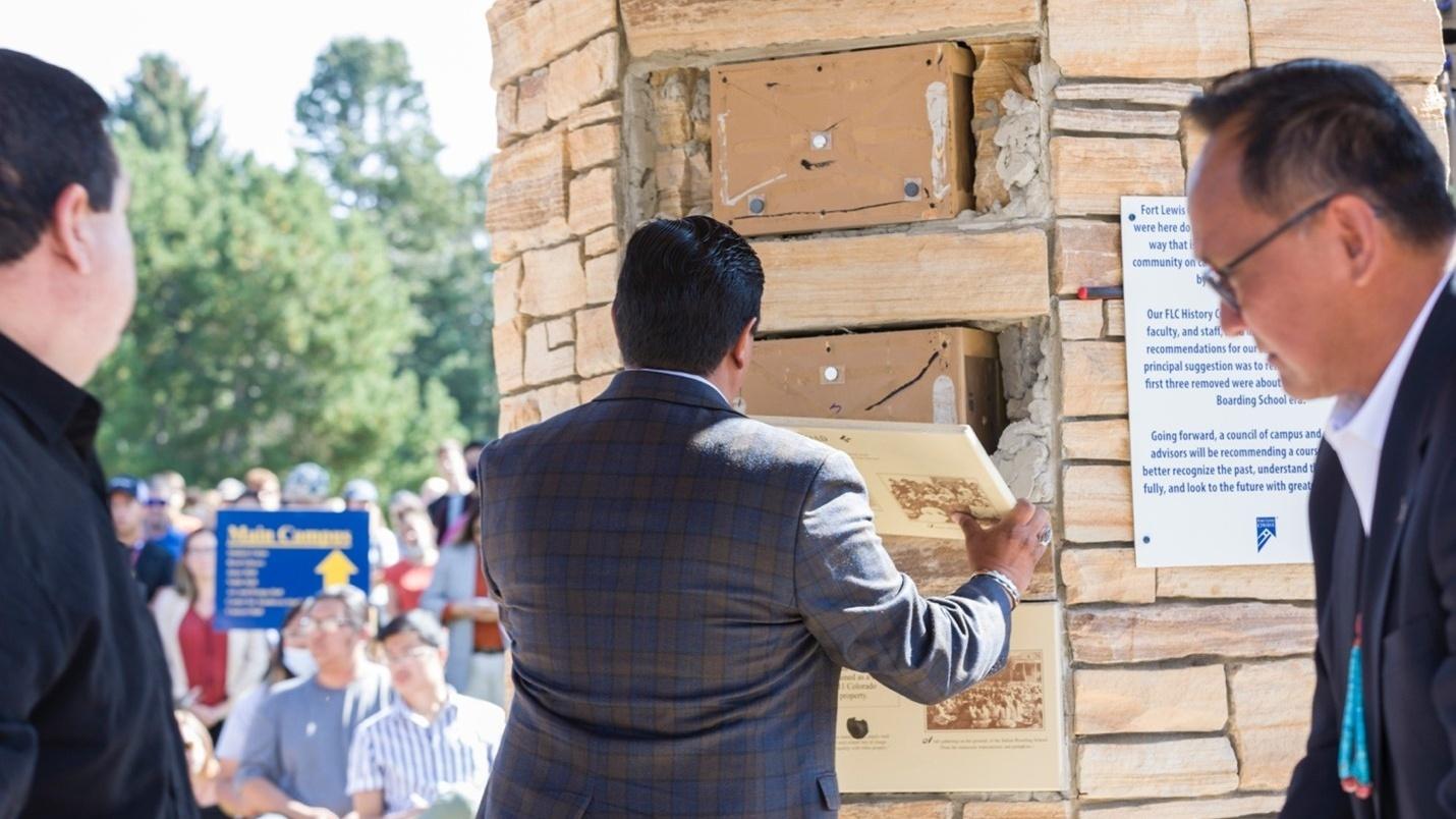 School officials remove the inaccurate panels from the clock tower at Fort Lewis College. The panels misrepresented the history of the former Indian Boarding School at Fort Lewis.