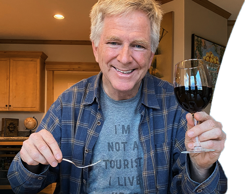 Rick Steves holding a glass of wine