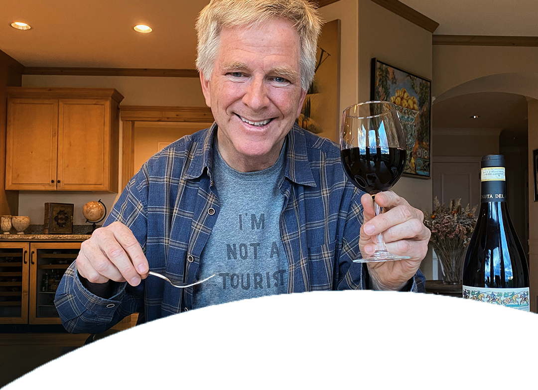 Rick Steves holding a glass of wine