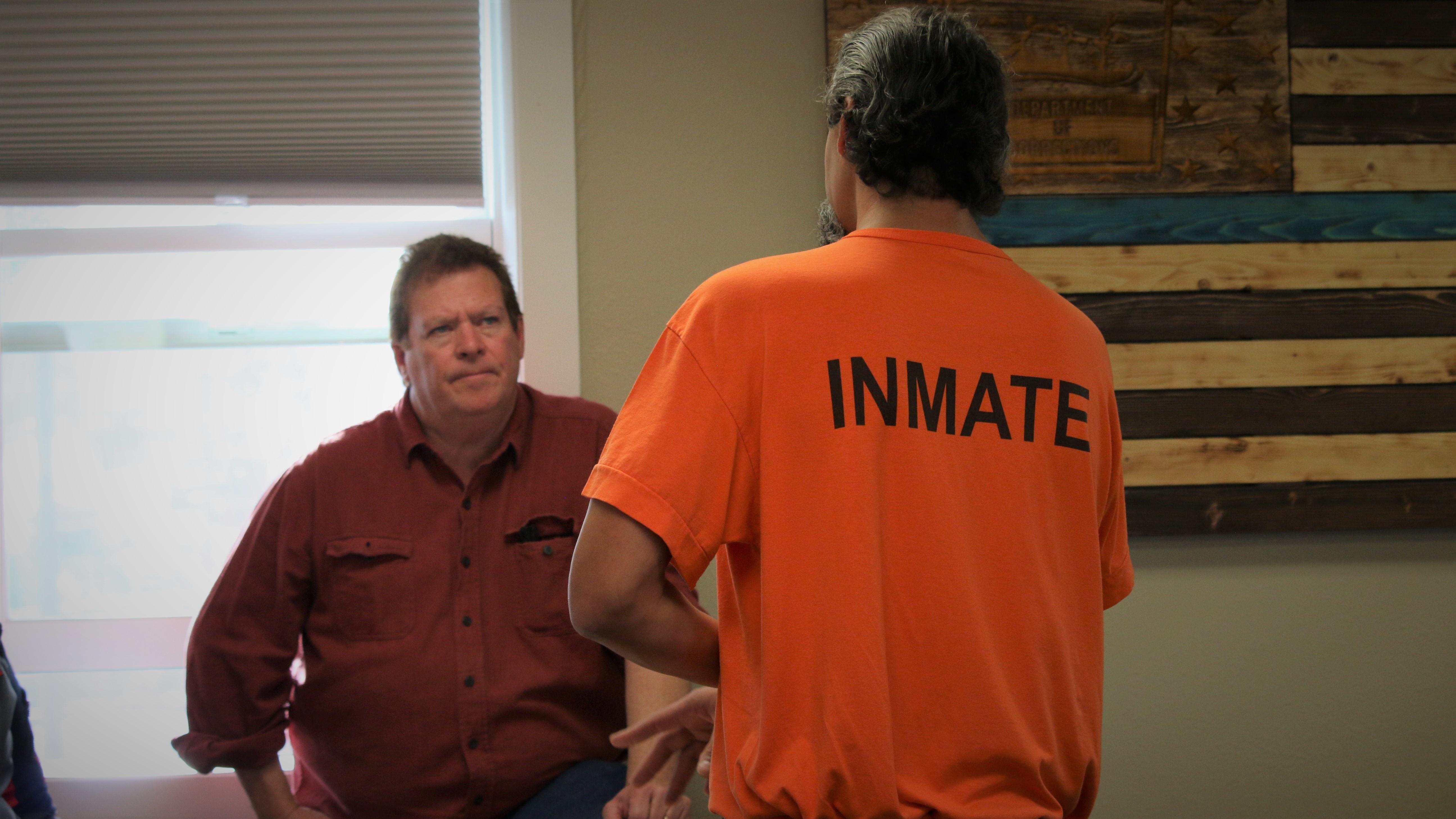 An inmate visits with a potential employer at the Second Chance Job Fair at the South Dakota State Penitentiary.
